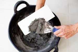 contruction mason worker hands with cement mortar spatula bucket and trowel