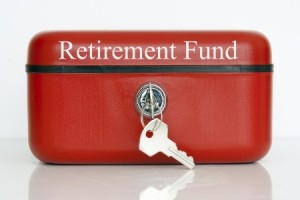 A closed red metal cash tin with Retirement Fund notice against a white background