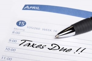 A date book communicates a reminder that taxes are due on April 15th
