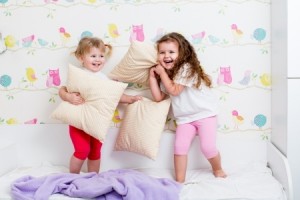 children sisters playing in bedroom