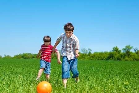 Kids playing with the ball in the countryside