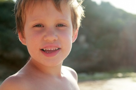 Portrait of happy 5 years old boy on the beach