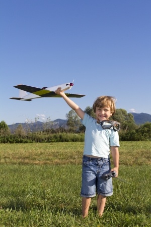 Smiling boy preparing to launch RC plane