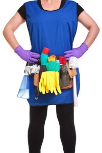 a cleaner wearing a tool belt full of cleaning equipment isolated on a white background