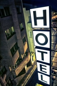 Illuminated hotel sign at night from a room