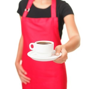 Waitress serving coffee cup Close up of hand showing coffee isolated on white background