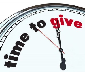 An ornate clock with the words Time to Give on its face