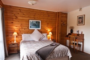 Nice warm bedroom interior of mountain lodge. Fox Glacier Lodge, Fox Glacier, West Coast, South Island, New Zealand.