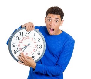 student holding a clock