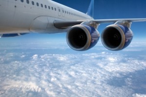 Big airliner in the blue sky with clouds.