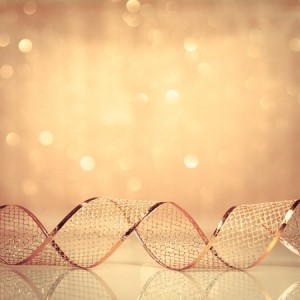 Gold Christmas ribbon ornament on background