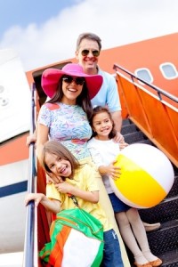 Happy family going on holidays by airplane