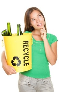 Recycle woman thinking looking up at copy space. Beautiful young woman holding recycling basket isolated on white background.