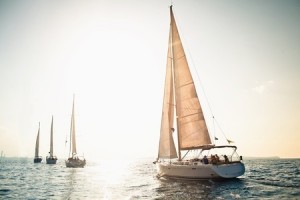 Sailing ship yachts with white sails in a row