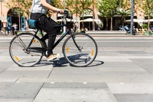 Unidentifiable female person riding a bicycle in the city