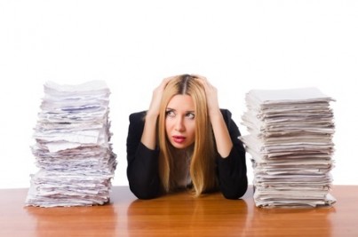 Woman with pile of papers