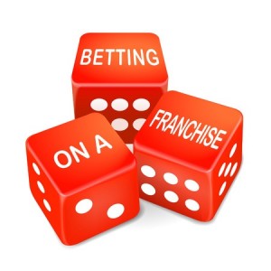 betting on a franchise words on three red dice over white background