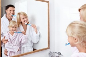 Family brushing their teeth in the bathroom