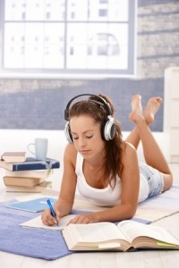 Attractive girl learning at home laying on floor