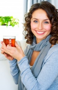 Beautiful Young Woman drinking hot tea