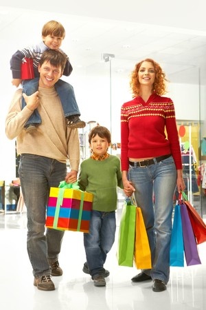 Image of family carrying bags and box before Christmas time