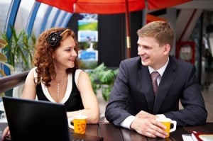 Joyful man and woman on business lunch in cafe