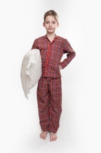 Little boy in pyjamas holding a pillow