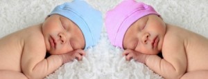Newborn babies asleep on a white blanket