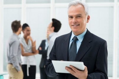 Portrait Of Senior Businessman Holding Digital Tablet at Office