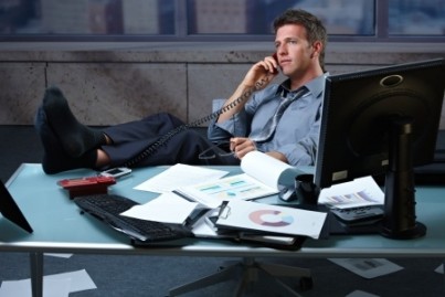 Tired businessman taking break speaking on landline phone