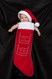 A young child inside a christmas stocking