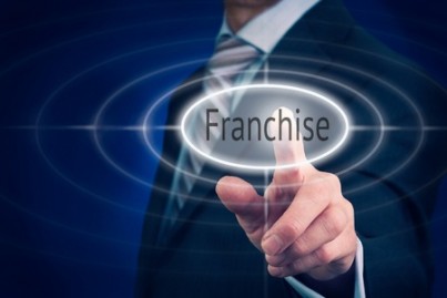Businessman pressing a Franchise concept button
