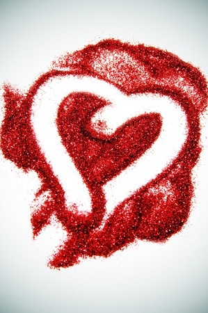 a heart drawn on red glitter on a vignetting background