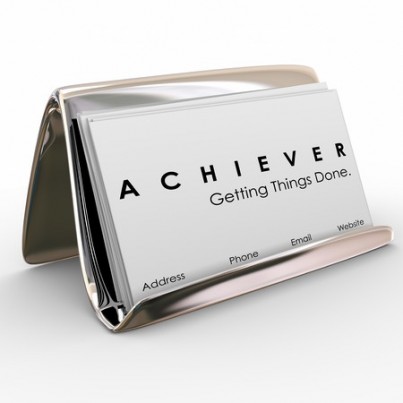 Achiever word on business cards in a holder to promote your expertise