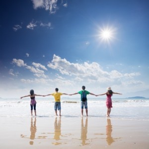 friends holding together on beach