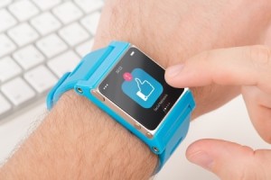 Male finger taps like icon on blue smart watch