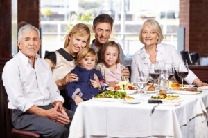 Portrait of a happy family with children and grandparents at the dining table