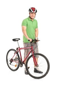 Full length portrait of a smiling man posing with a mountain bike isolated on white background
