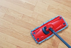 Cleaning laminate. Red mop on hardwood floors.