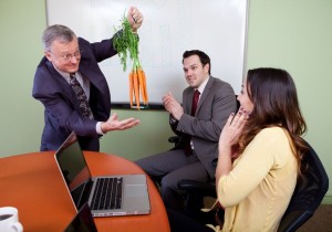 The great motivator dangling carrots and Business team motivated by positive presenter