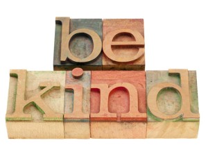 be kind motivational reminder - phrase in vintage wood letterpress type, stained by color inks, isolated on white