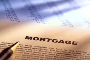Residential real estate mortgage application document form over financial figures paperwork for a loan transaction lender approval processing and commitment with ink pen