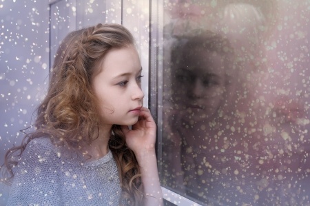 teen girl looking out the window