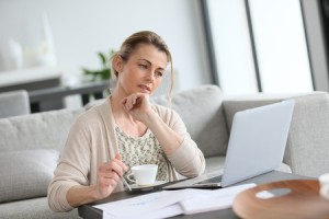 38883684 - middle-aged woman working from home on laptop