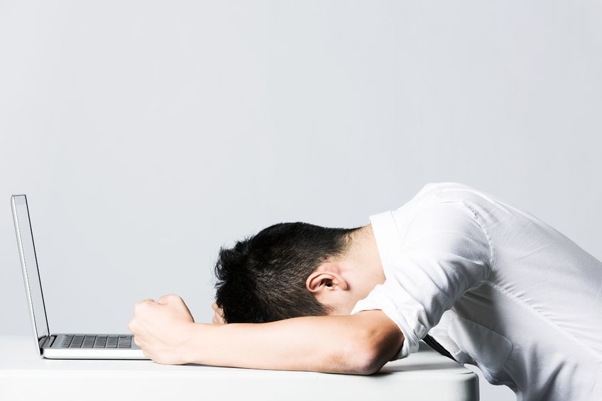 Stressed Asian Business man due to the of amount of work he has to do