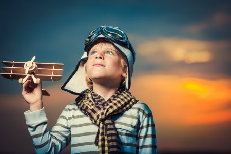 22349951 - boy with plane at sunset