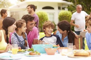 33549411 - multi generation family enjoying meal in garden together