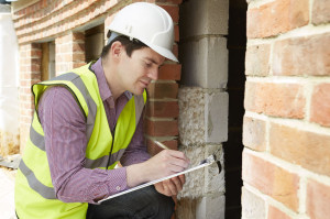 42647617 - architect checking insulation during house construction