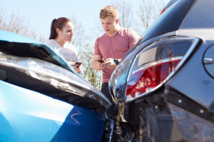 28154932 - two drivers exchange insurance details after accident