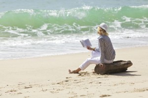 8117936 - woman with book is sitting on a stump by the wave line